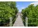 Scenic walkway through lush greenery leading to a serene waterfront home with a dock at 12769 Foresman Blvd, Port Charlotte, FL 33981