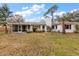 Spacious backyard featuring a well-maintained lawn and home with red-trimmed windows at 12845 95Th N St, Largo, FL 33773