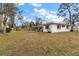 Large backyard with ample green space and a view of the home's exterior at 12845 95Th N St, Largo, FL 33773