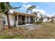 View of the home's backyard featuring a screened porch and partial fencing at 12845 95Th N St, Largo, FL 33773