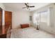 Bedroom with a ceiling fan, carpeted flooring, a window, and minimal furniture at 12845 95Th N St, Largo, FL 33773