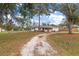 Wide view of a single-story home with a well-kept lawn and decorative front yard at 12845 95Th N St, Largo, FL 33773