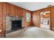 Cozy living room features wood-paneled walls and stone fireplace, creating a warm and inviting ambiance at 12845 95Th N St, Largo, FL 33773