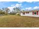 Expansive yard space with home featuring bright accents and mature trees at 12845 95Th N St, Largo, FL 33773