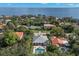 Aerial view of a luxury home, mature trees, and a pool overlooking the bay at 140 Miramar Ne Blvd, St Petersburg, FL 33704