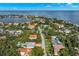 Beautiful aerial view of a home near the bay waters, surrounded by lush trees and tropical landscaping at 140 Miramar Ne Blvd, St Petersburg, FL 33704