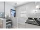 Bright bathroom featuring a vanity with a black countertop, a makeup station, and large windows for natural light at 140 Miramar Ne Blvd, St Petersburg, FL 33704