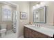 Traditional bathroom featuring a dark wood vanity with a white countertop and a view into the shower at 140 Miramar Ne Blvd, St Petersburg, FL 33704