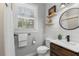 Modern farmhouse style bathroom with shiplap walls, a floating wood vanity, and stylish fixtures at 140 Miramar Ne Blvd, St Petersburg, FL 33704