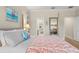 Bright bedroom featuring a bed with a coral patterned quilt, neutral walls, and wood floors at 140 Miramar Ne Blvd, St Petersburg, FL 33704