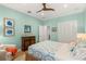 Bright bedroom with seafoam-colored walls, a woven bed frame, and windows with plantation shutters at 140 Miramar Ne Blvd, St Petersburg, FL 33704