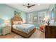 Bright bedroom with seafoam-colored walls, a woven bed frame, and windows with plantation shutters at 140 Miramar Ne Blvd, St Petersburg, FL 33704