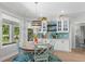 Bright breakfast nook with a round table, chairs, and decorative accents on the adjacent coffee bar at 140 Miramar Ne Blvd, St Petersburg, FL 33704