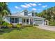 Charming two-story coastal home with a well-manicured lawn and colorful landscaping at 140 Miramar Ne Blvd, St Petersburg, FL 33704