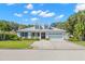 Charming two-story home with a well-manicured lawn, a quaint front porch, and a two-car garage at 140 Miramar Ne Blvd, St Petersburg, FL 33704