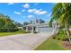 Charming two-story home featuring a quaint front porch, a well-manicured lawn, and a two-car garage at 140 Miramar Ne Blvd, St Petersburg, FL 33704