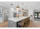 Bright kitchen with white cabinetry, stainless steel appliances, large center island, and designer tile backsplash at 140 Miramar Ne Blvd, St Petersburg, FL 33704