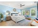 Serene main bedroom with soft blue walls, a cozy sitting area, and ample natural light at 140 Miramar Ne Blvd, St Petersburg, FL 33704