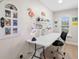 Bright home office featuring a clean white desk, flamingo decor, and natural light at 140 Miramar Ne Blvd, St Petersburg, FL 33704