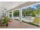 Outdoor living area with a covered porch, and a view of the pool area with patio furniture at 140 Miramar Ne Blvd, St Petersburg, FL 33704