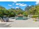 Inviting pool area surrounded by lush landscaping, patio, and comfortable seating under colorful umbrellas at 140 Miramar Ne Blvd, St Petersburg, FL 33704