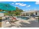 Beautiful backyard pool featuring a sun shelf, lush landscaping, and a spacious patio for entertaining at 140 Miramar Ne Blvd, St Petersburg, FL 33704