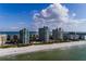 An aerial view showcases the condominium community next to the beach and ocean at 1540 Gulf Blvd # Ph7, Clearwater Beach, FL 33767