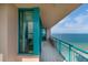 Long, tiled balcony with turquoise railings and windows, showcasing stunning ocean views at 1540 Gulf Blvd # Ph7, Clearwater Beach, FL 33767