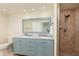 Bathroom featuring double sinks, large framed mirror and tiled shower stall at 1540 Gulf Blvd # Ph7, Clearwater Beach, FL 33767