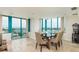 Dining room with tile floors, modern furnishings, and large windows with ocean views at 1540 Gulf Blvd # Ph7, Clearwater Beach, FL 33767