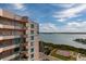 View of condo building with blue accents offering beautiful views of the water and tennis courts at 1540 Gulf Blvd # Ph7, Clearwater Beach, FL 33767