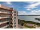 View of condo building with blue accents offering beautiful views of the water and tennis courts at 1540 Gulf Blvd # Ph7, Clearwater Beach, FL 33767