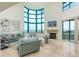 Bright living room featuring expansive windows and a fireplace at 1540 Gulf Blvd # Ph7, Clearwater Beach, FL 33767