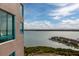 Scenic water view from a condo balcony with a blue railing, overlooking a charming coastal community at 1540 Gulf Blvd # Ph7, Clearwater Beach, FL 33767