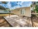 Backyard wooden deck with sunny view of neighboring homes and minimal landscaping at 185 New England Ave # 33, Palm Harbor, FL 34684