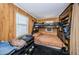 Cozy bedroom featuring wood paneling, a bunk bed, and a window for natural light at 185 New England Ave # 33, Palm Harbor, FL 34684