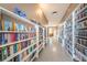 Community library featuring rows of bookshelves filled with books and an orange chair at the end of the hall at 185 New England Ave # 33, Palm Harbor, FL 34684