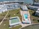 Aerial view of the community pool, shuffleboard, and manicured green spaces at 1868 Shore S Dr # 602, South Pasadena, FL 33707