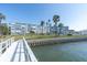 Condo building by the water, featuring tropical landscaping and waterfront access at 1868 Shore S Dr # 602, South Pasadena, FL 33707