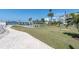 Well-maintained lawn with shuffleboard courts and tropical landscaping by the waterfront at 1868 Shore S Dr # 602, South Pasadena, FL 33707