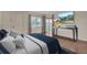 Staged main bedroom with hardwood floors, neutral color palette, and a view of the ocean at 204 Mary Dr, Oldsmar, FL 34677