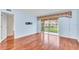 Bedroom featuring hardwood floors and a sliding glass door to the outside at 204 Mary Dr, Oldsmar, FL 34677