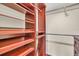 Walk-in closet with custom shelving and rods for organizing clothes and accessories at 204 Mary Dr, Oldsmar, FL 34677