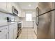 Stylish kitchen with stainless steel appliances, white cabinetry, and modern countertops at 2054 Pennsylvania Ave, Englewood, FL 34224