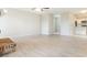 Open living room with new wood-look flooring and bright, neutral walls at 2054 Pennsylvania Ave, Englewood, FL 34224