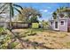 Expansive backyard featuring storage sheds and tropical trees at 2661 45Th S St, Gulfport, FL 33711