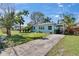 Charming single-story home featuring a well-manicured front yard and a welcoming pergola-covered entrance at 2661 45Th S St, Gulfport, FL 33711