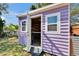 Charming purple shed with white trim, double doors, and windows at 2661 45Th S St, Gulfport, FL 33711