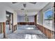 Spacious living room featuring large windows, ceiling fan, and some exposed studs awaiting renovation at 2661 45Th S St, Gulfport, FL 33711