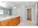 Bathroom with a large mirror above and sinks, leading to a walk-in shower at 3206 Duchess Ct, Plant City, FL 33565